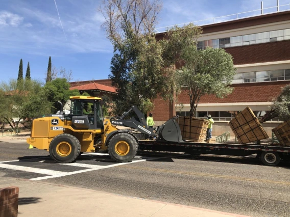 The monumental task of unloading the boxed trees on campus begins!